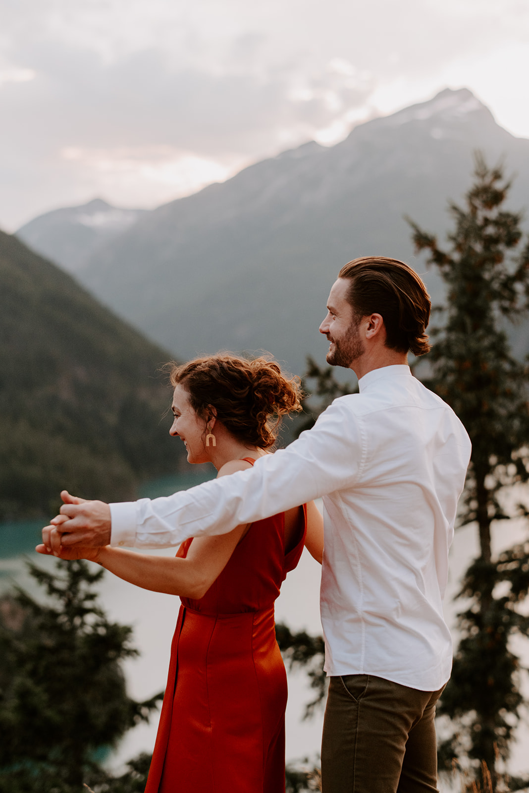 a couple dances together at the top of an overlook during their diablo lake engagement session
