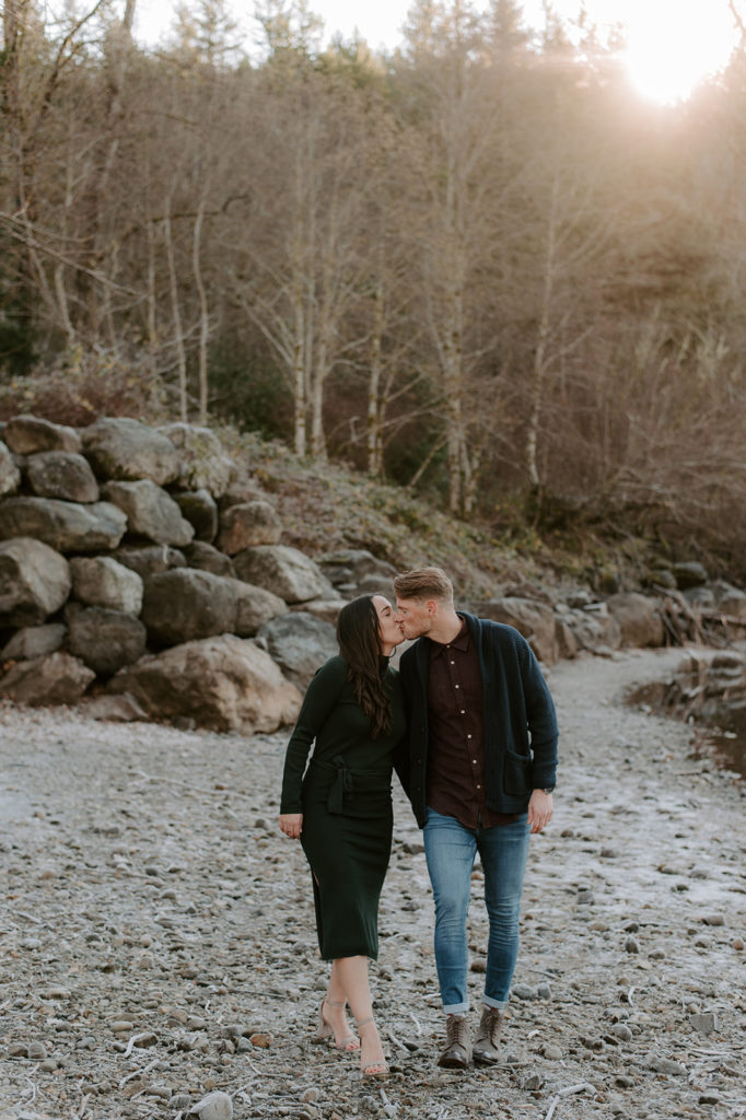 beautiful portrait of a couple walking around at a hill area and kissing