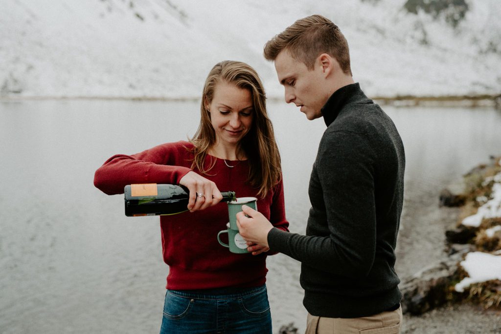 couple standing together filling wine glass