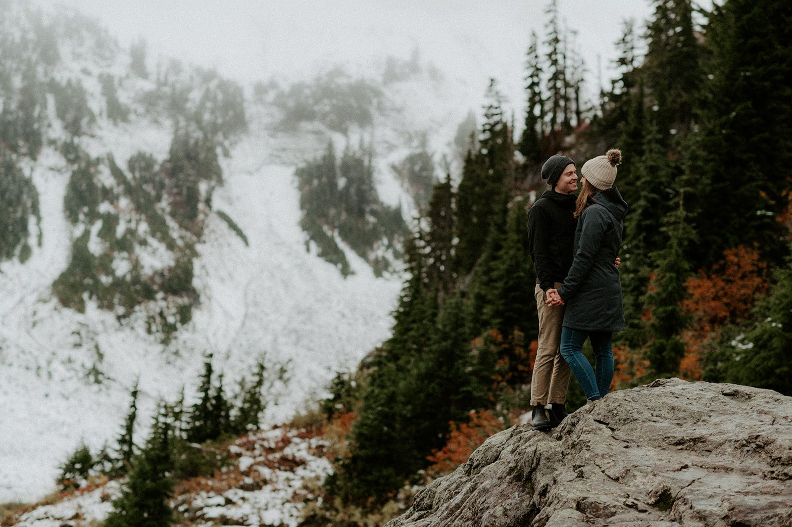 beautiful couple kissing standing on a hill point