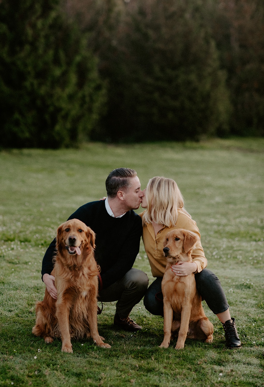 Couple kissing while holding their dogs at Gas Works Park