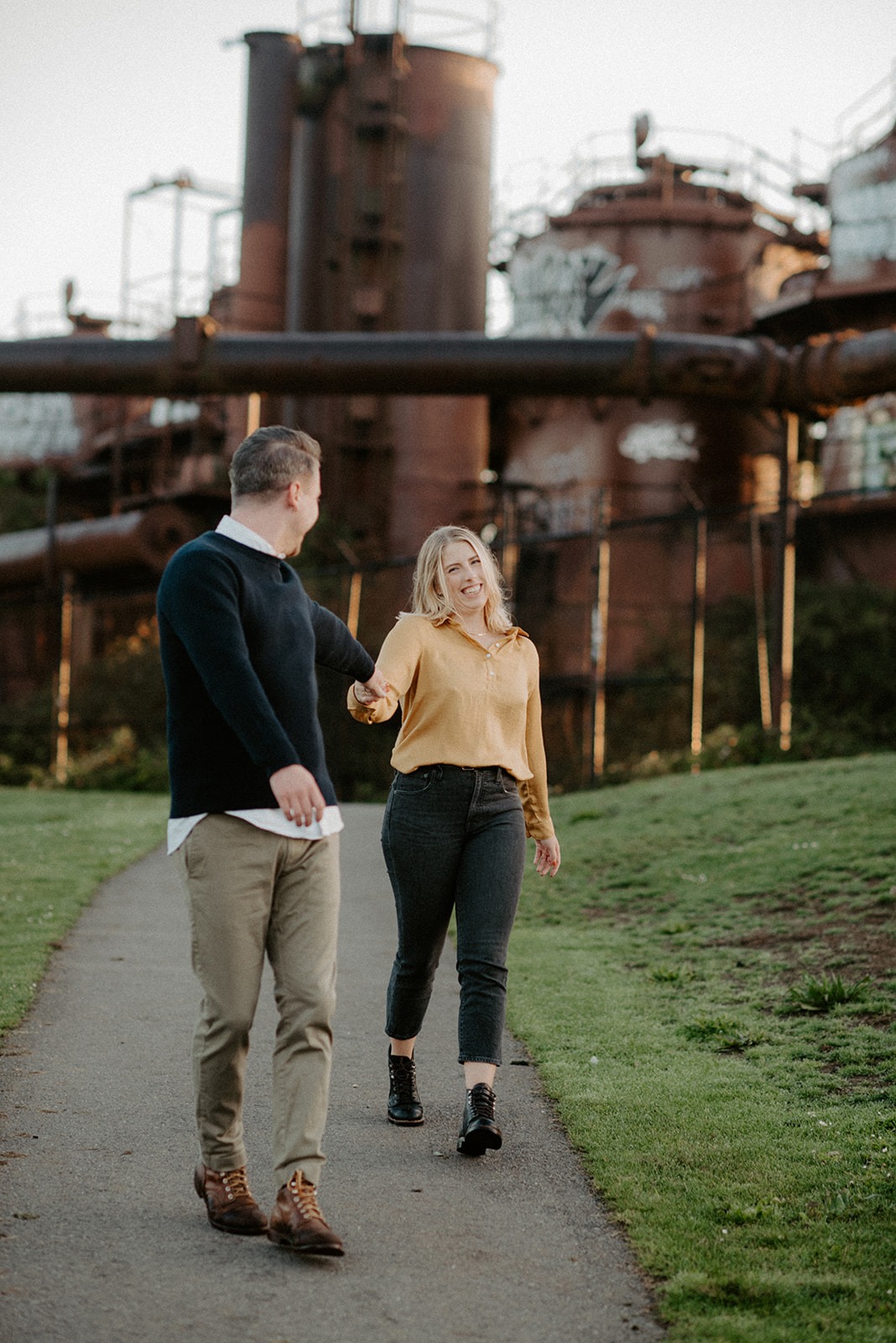 Couple walking near the historic gas plant structures at Gas Works Park