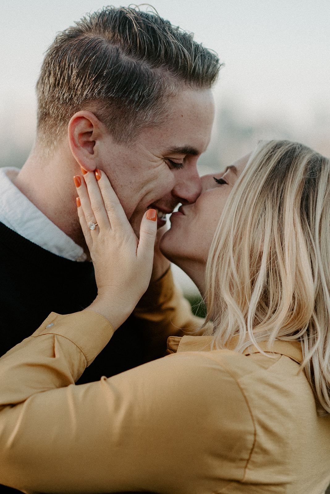 Close-up of couple kissing with engagement ring visible at Gas Works Park
