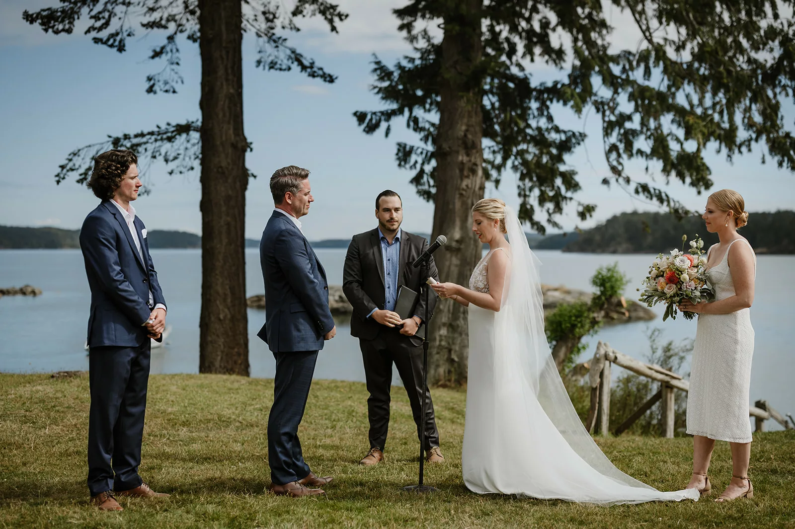 bride and groom take their wedding vows by the ocean overlook on pebble cove farm