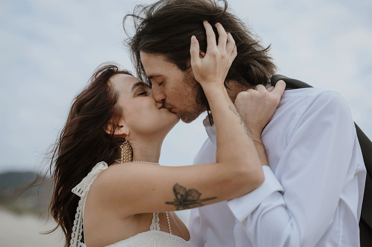 Engaged couple sharing a romantic kiss on the Oregon coast