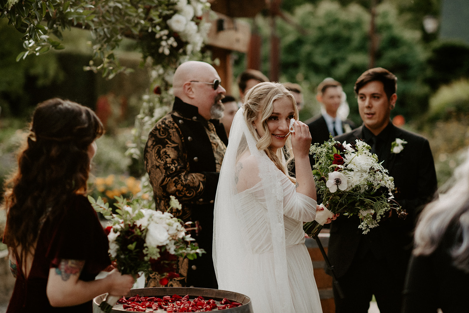 Bride wiping tears during the ceremony at the altar, overcome with emotion as the officiant speaks