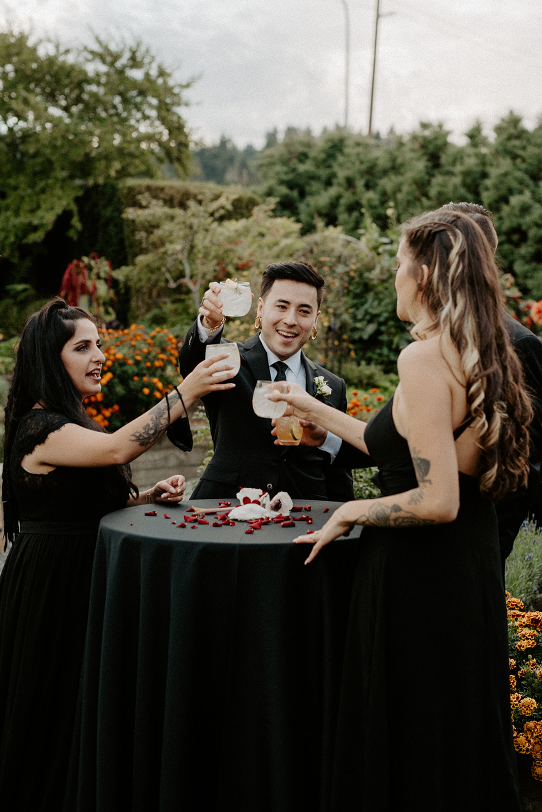 Newlyweds toasting with guests during cocktail hour in the Willows Lodge garden