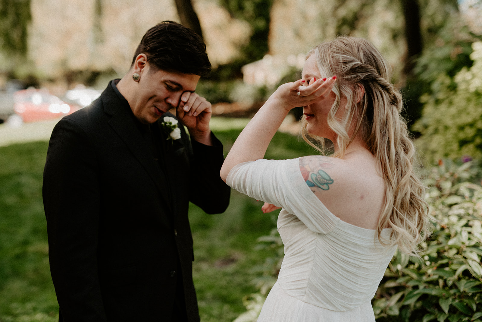 Bride and groom both wiping tears during their first look, an emotional and unposed moment at their Willows Lodge wedding