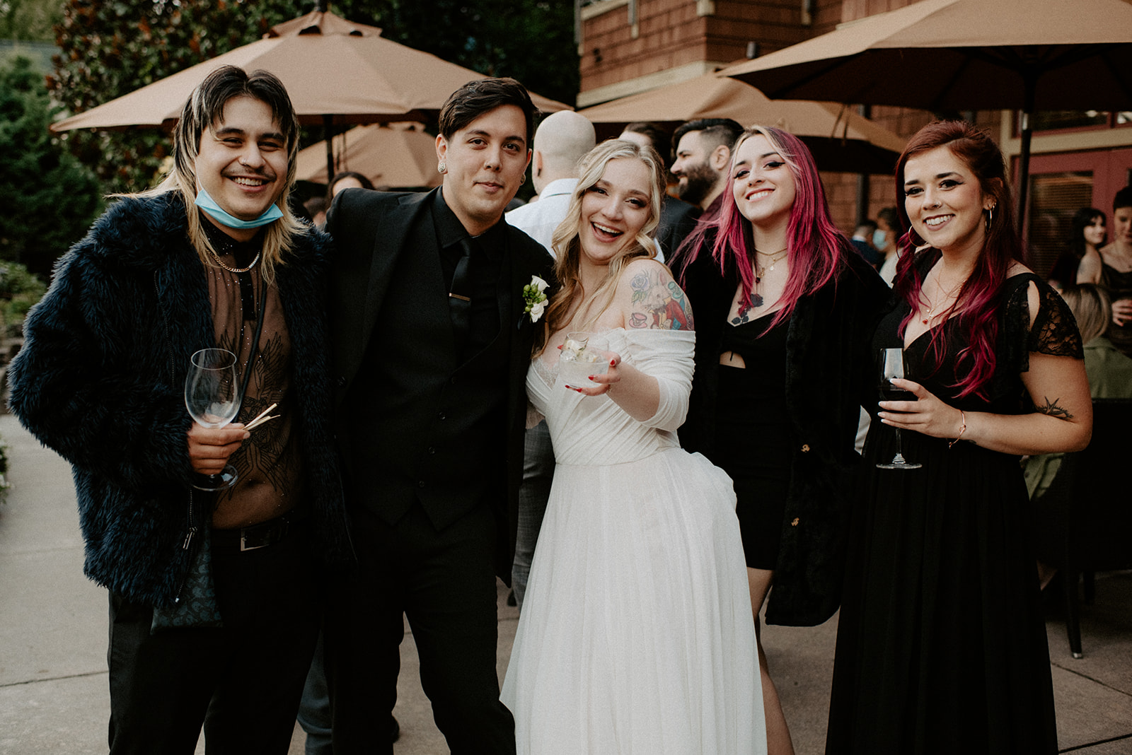Bride and groom celebrating with their group of friends during cocktail hour at Willows Lodge, everyone laughing and smiling