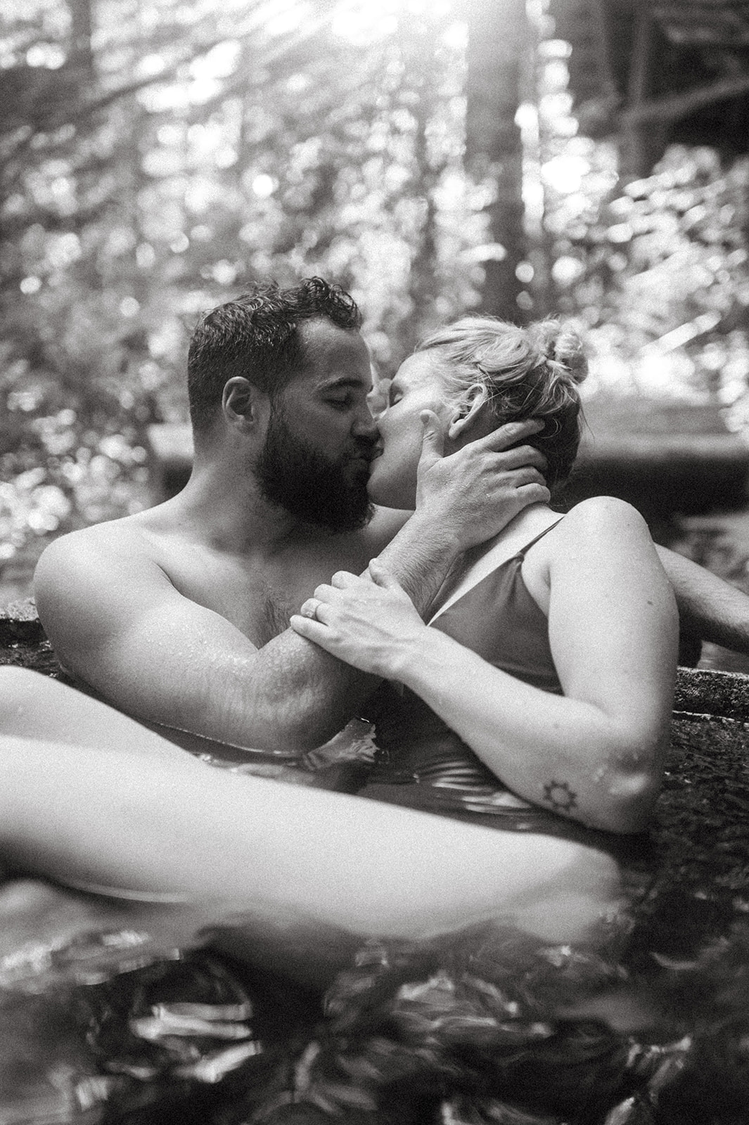 R and M sharing a kiss in a natural hot spring.