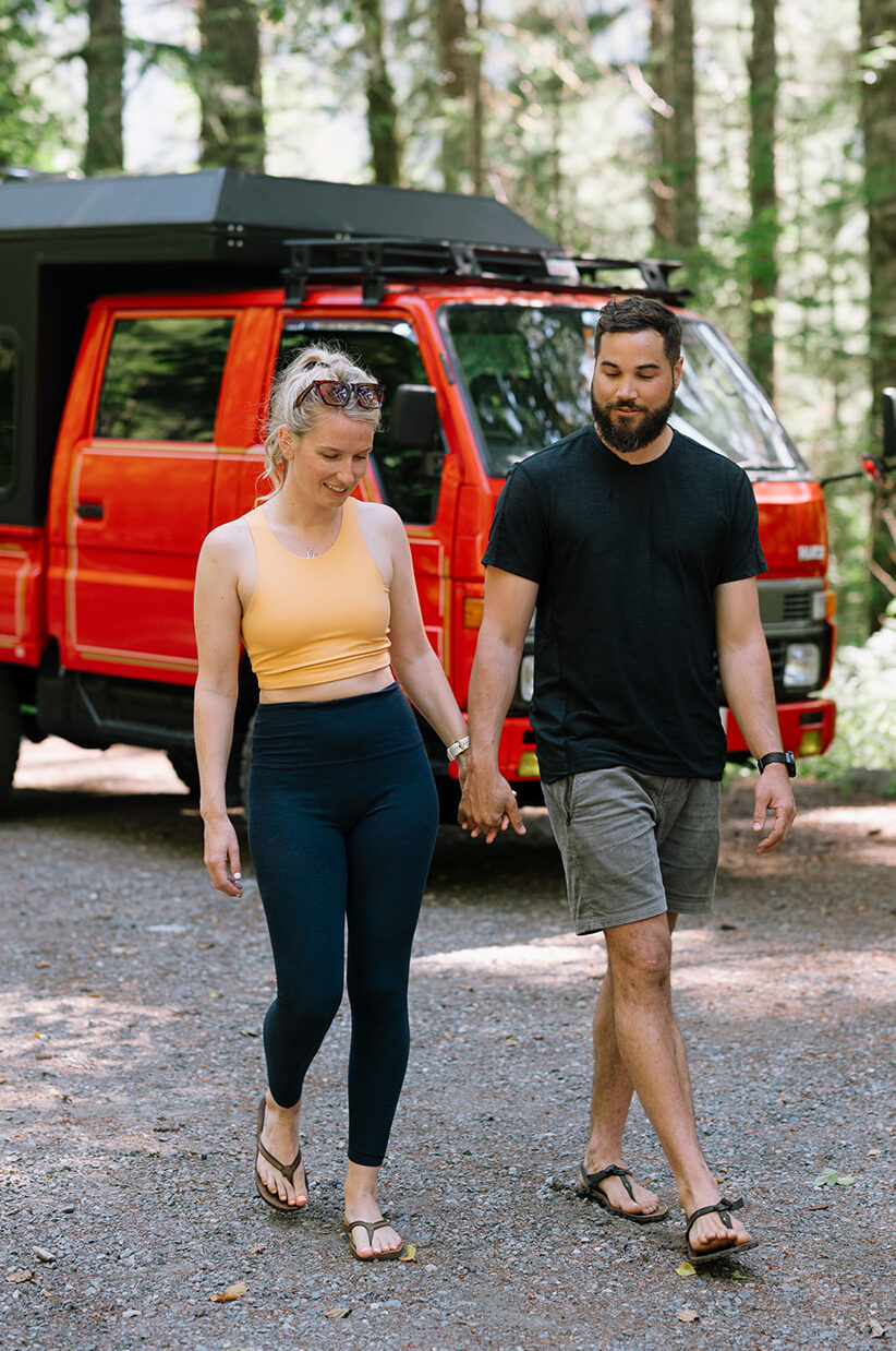 R and M holding hands while walking near their fire truck.