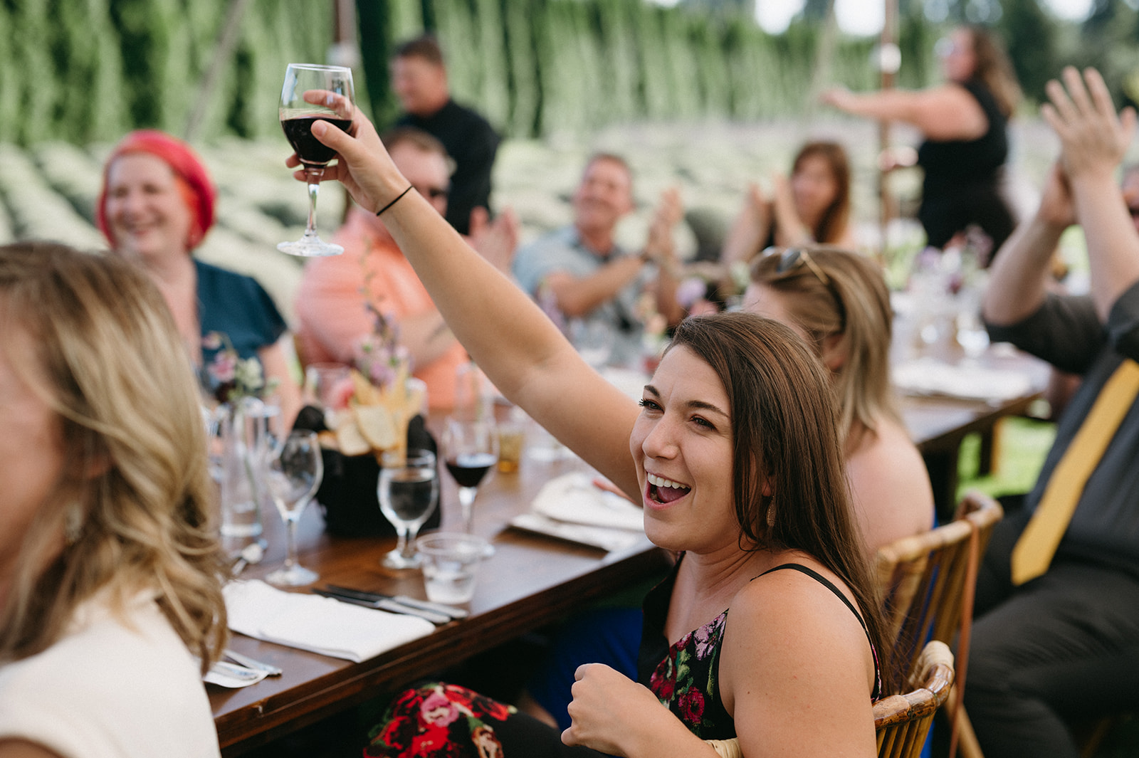 Guest raising glass and laughing during reception