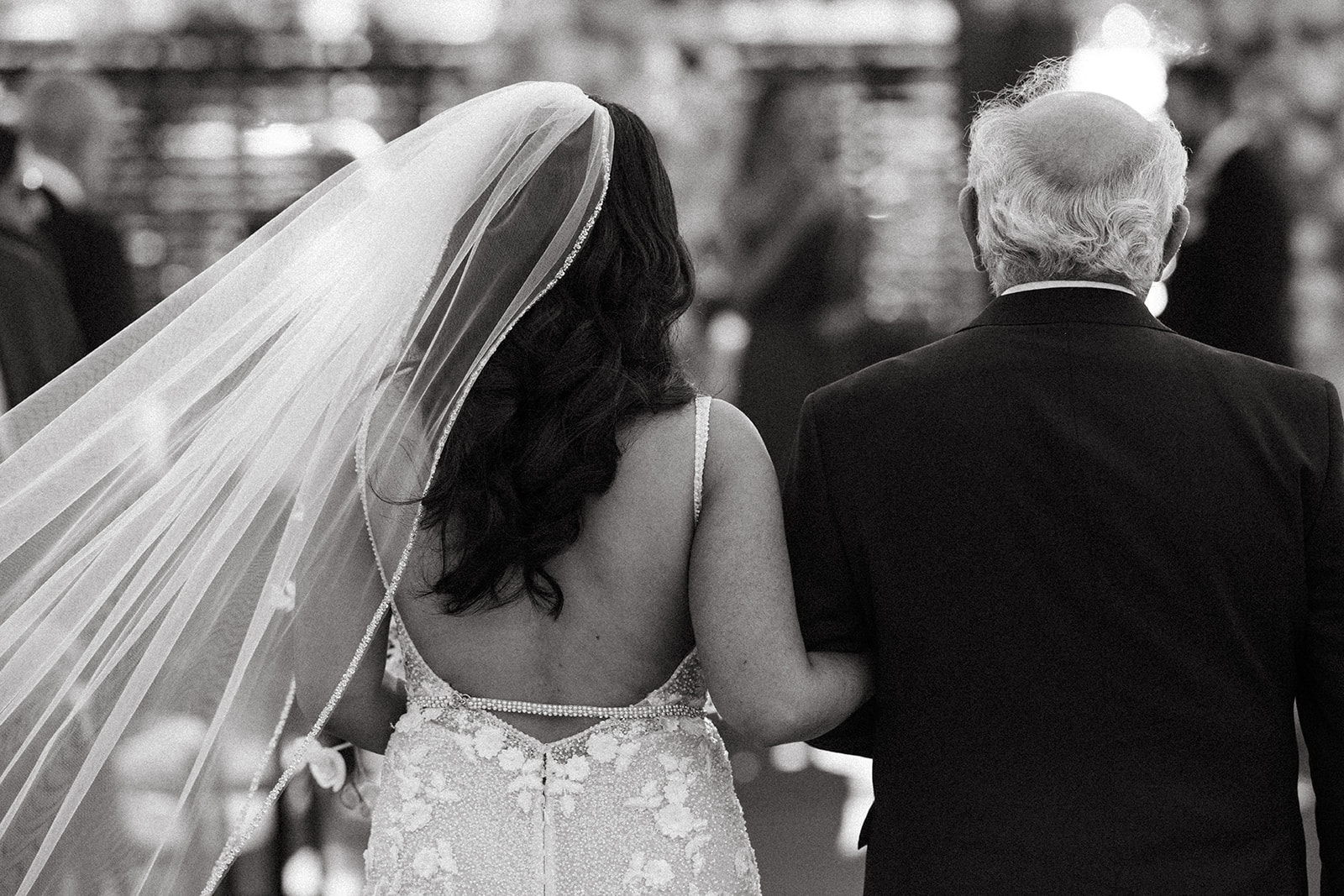 Close-up of bride and stepfather walking down the aisle at a Dockside at Duke’s wedding.