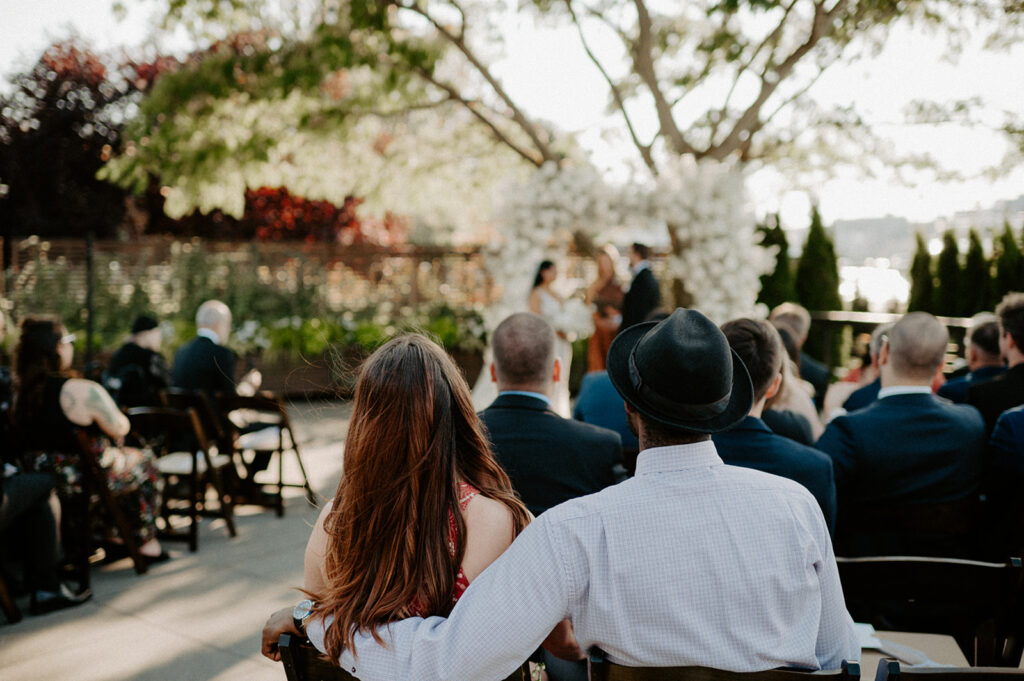 Guests watching the couple exchange vows at their Dockside at Duke’s wedding ceremony.