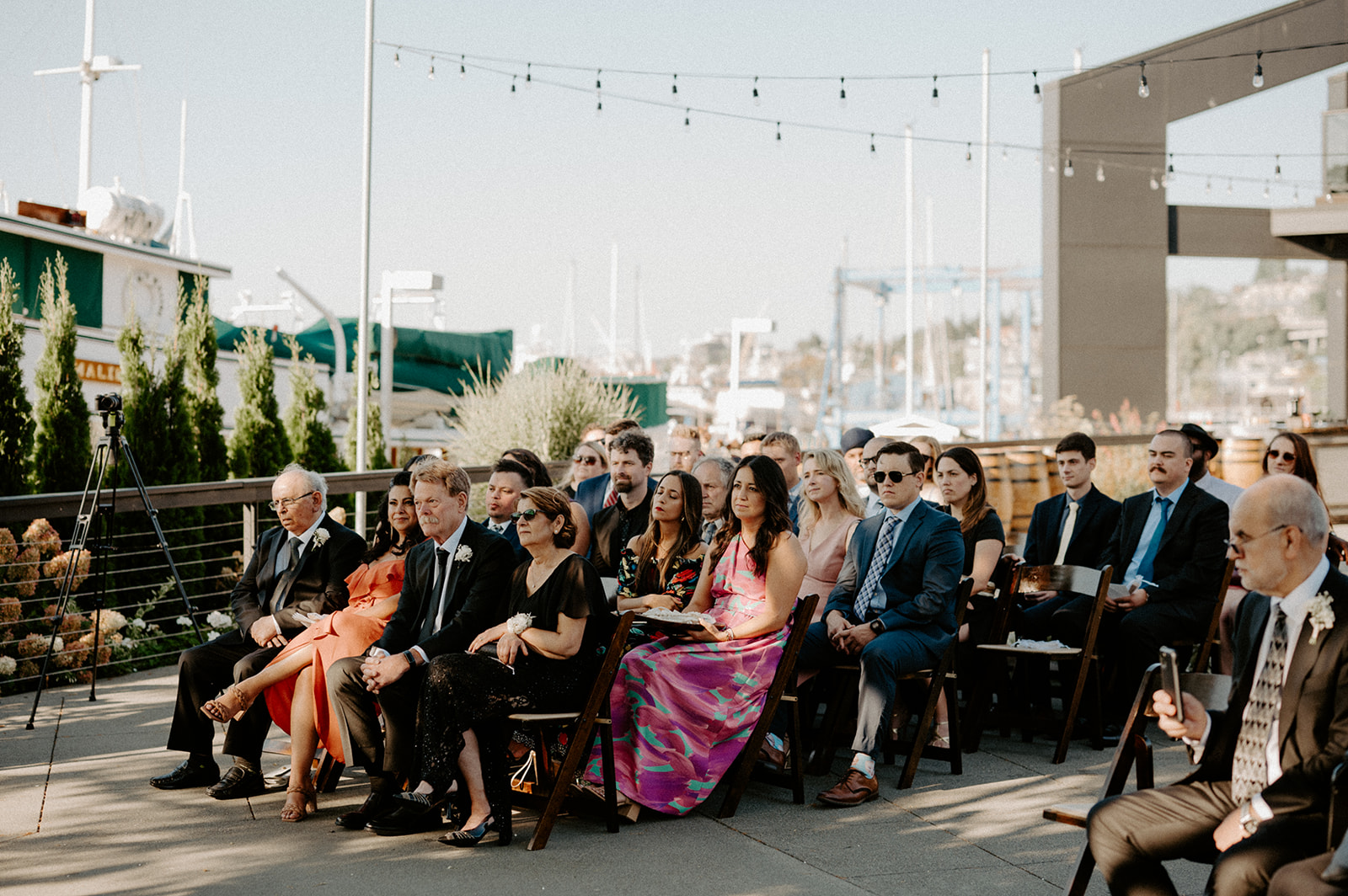 Wedding guests sitting outdoors at Dockside at Duke’s, watching the ceremony unfold.