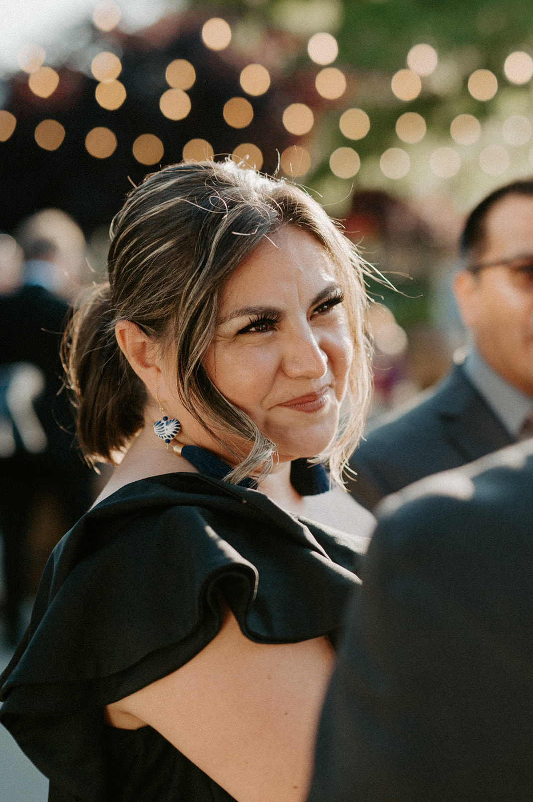 Wedding guest smiling warmly during the cocktail hour at Dockside at Duke’s wedding.