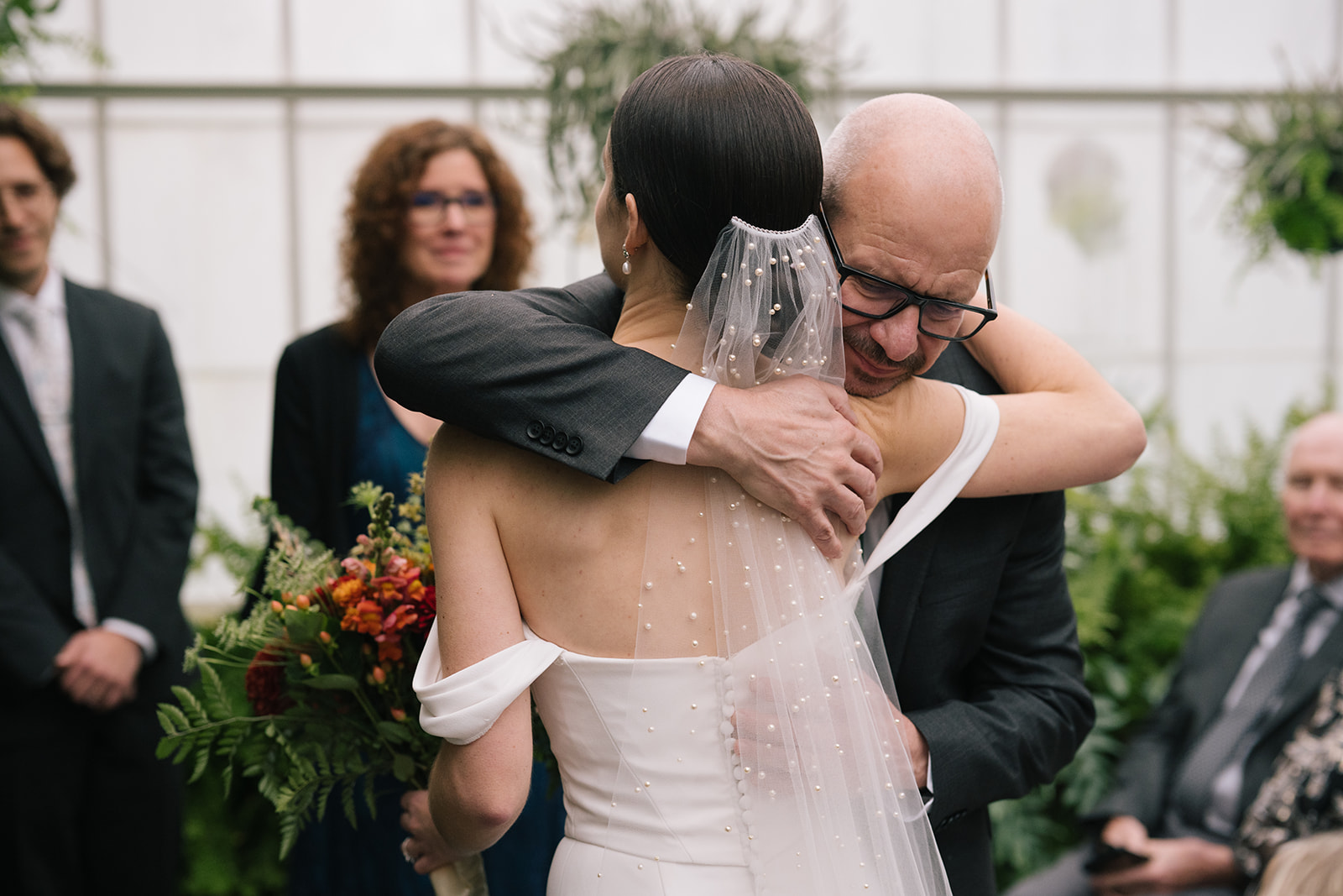 Taylor embracing her father with an emotional smile during the ceremony.