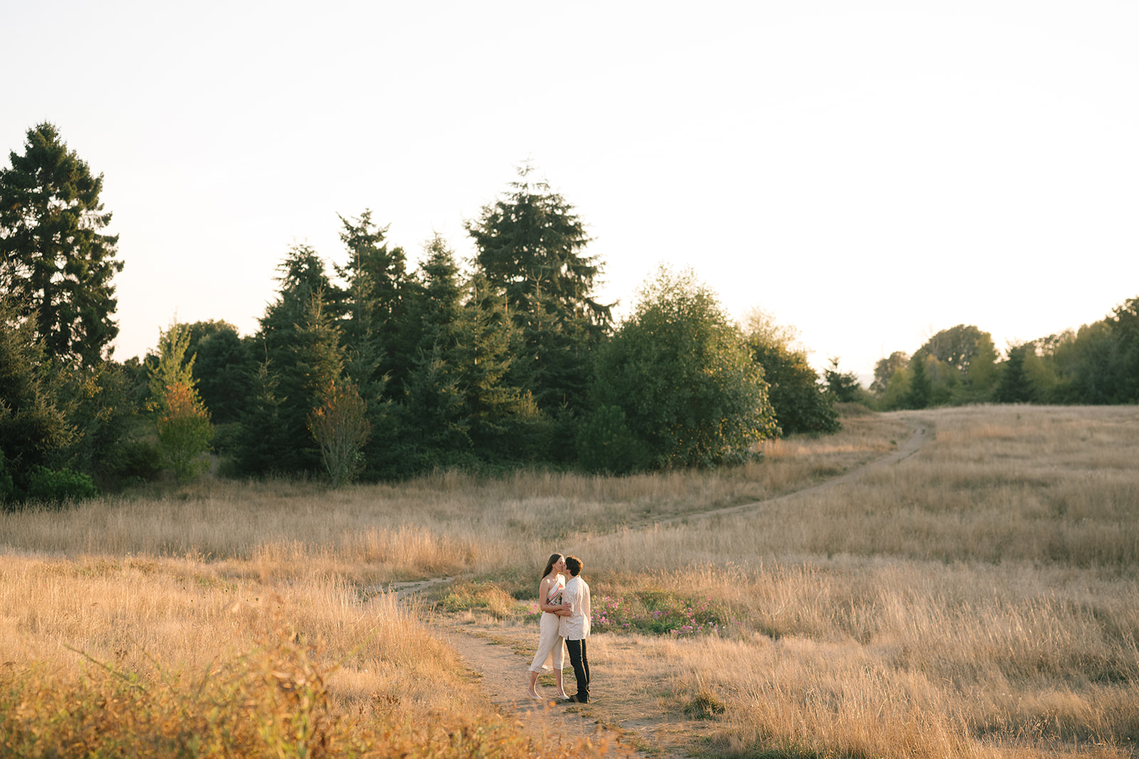 Couple in coordinated neutral outfits for outdoor engagement session