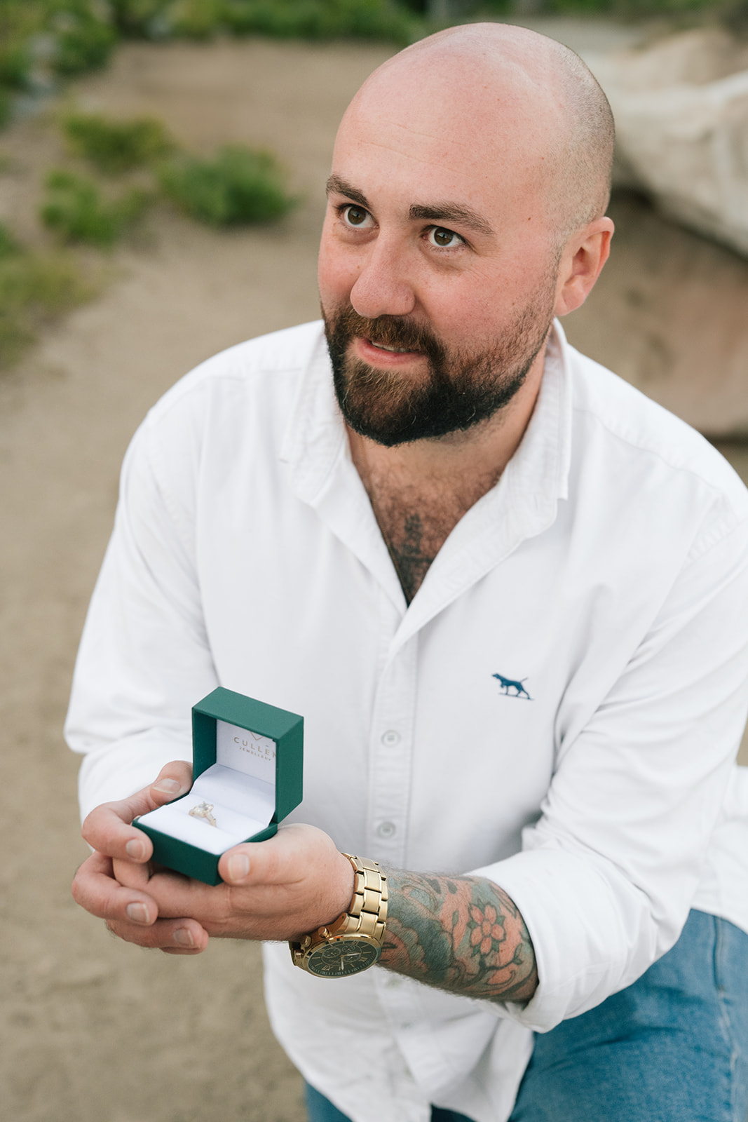 Fiancé-to-be smiles as he holds the open ring box moments after proposing at Mount Rainier
