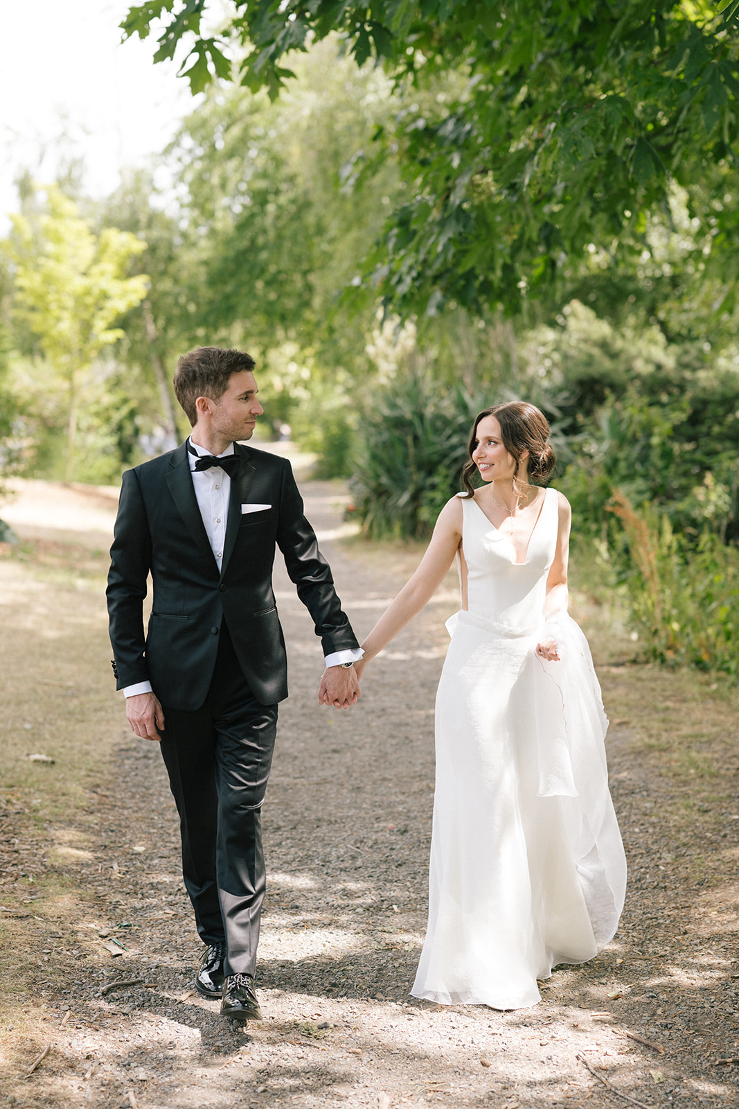 Bride and groom laughing together while walking during their Fremont Foundry wedding portraits