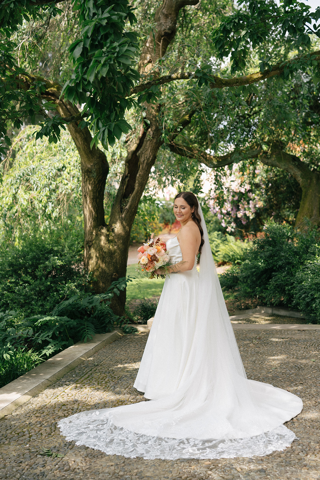 Editorial-style bridal portrait framed by greenery