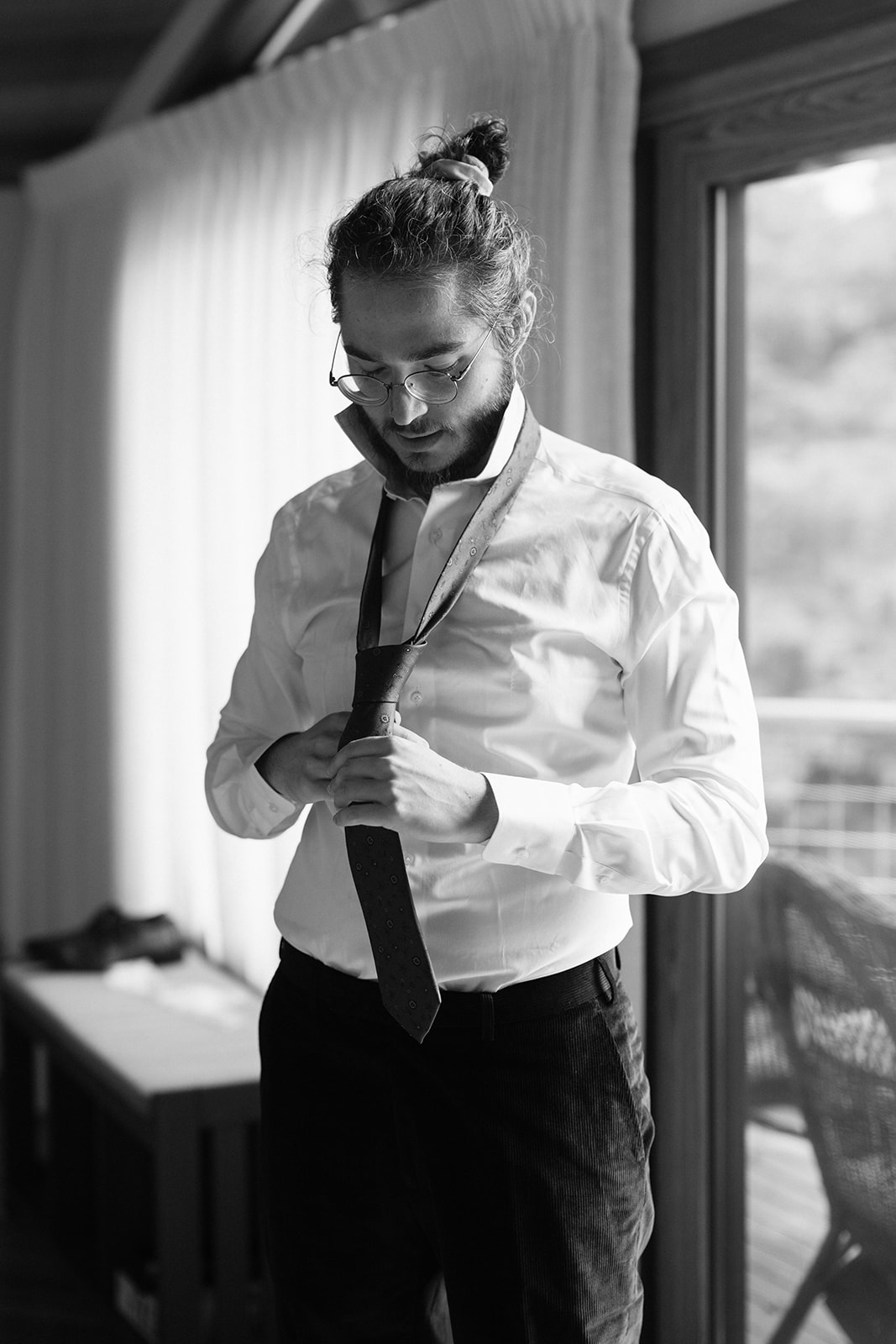Groom adjusting tie before Seattle wedding ceremony