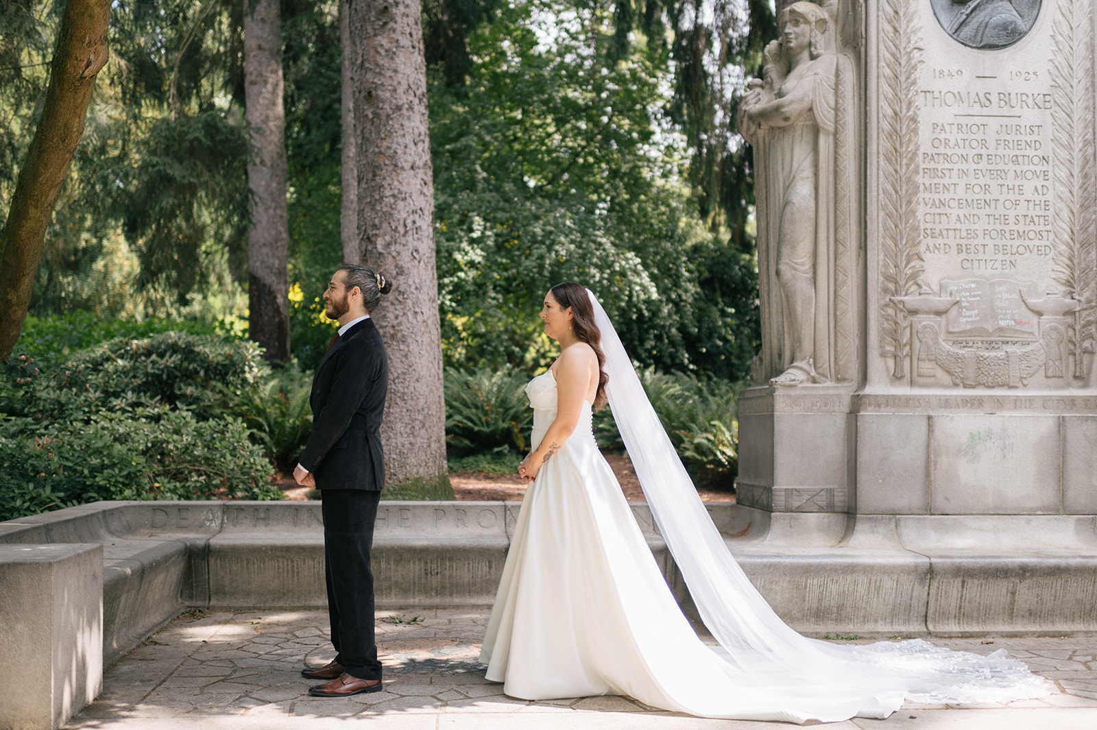 Bride and groom sharing their first look under trees at Volunteer Park