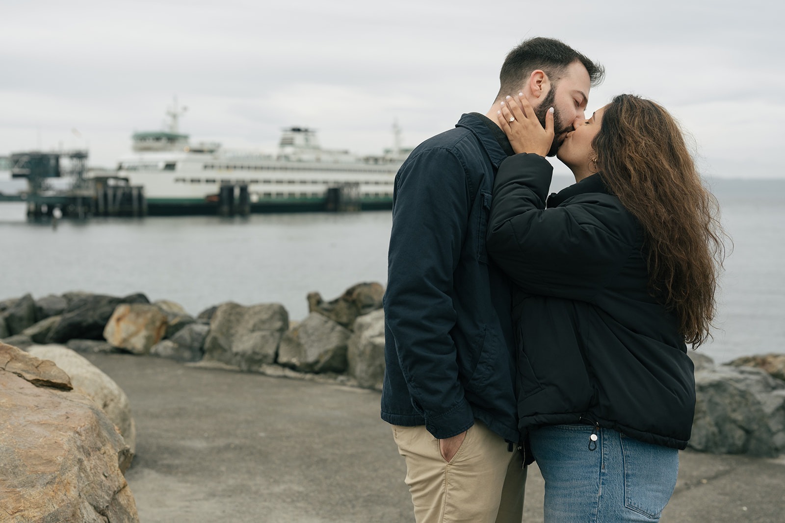 Brad and Aysha share a quiet kiss during their surprise waterfront proposal in the Pacific Northwest.
