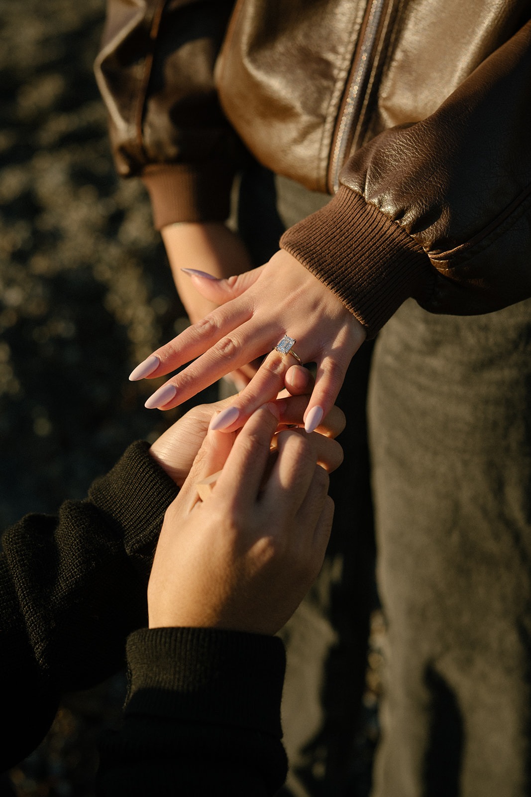 Engagement ring being placed on her finger during a surprise Pocket Beach proposal in Seattle