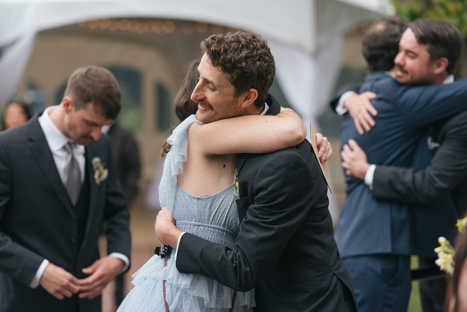 Wedding guests embracing during cocktail hour at Lairmont Manor