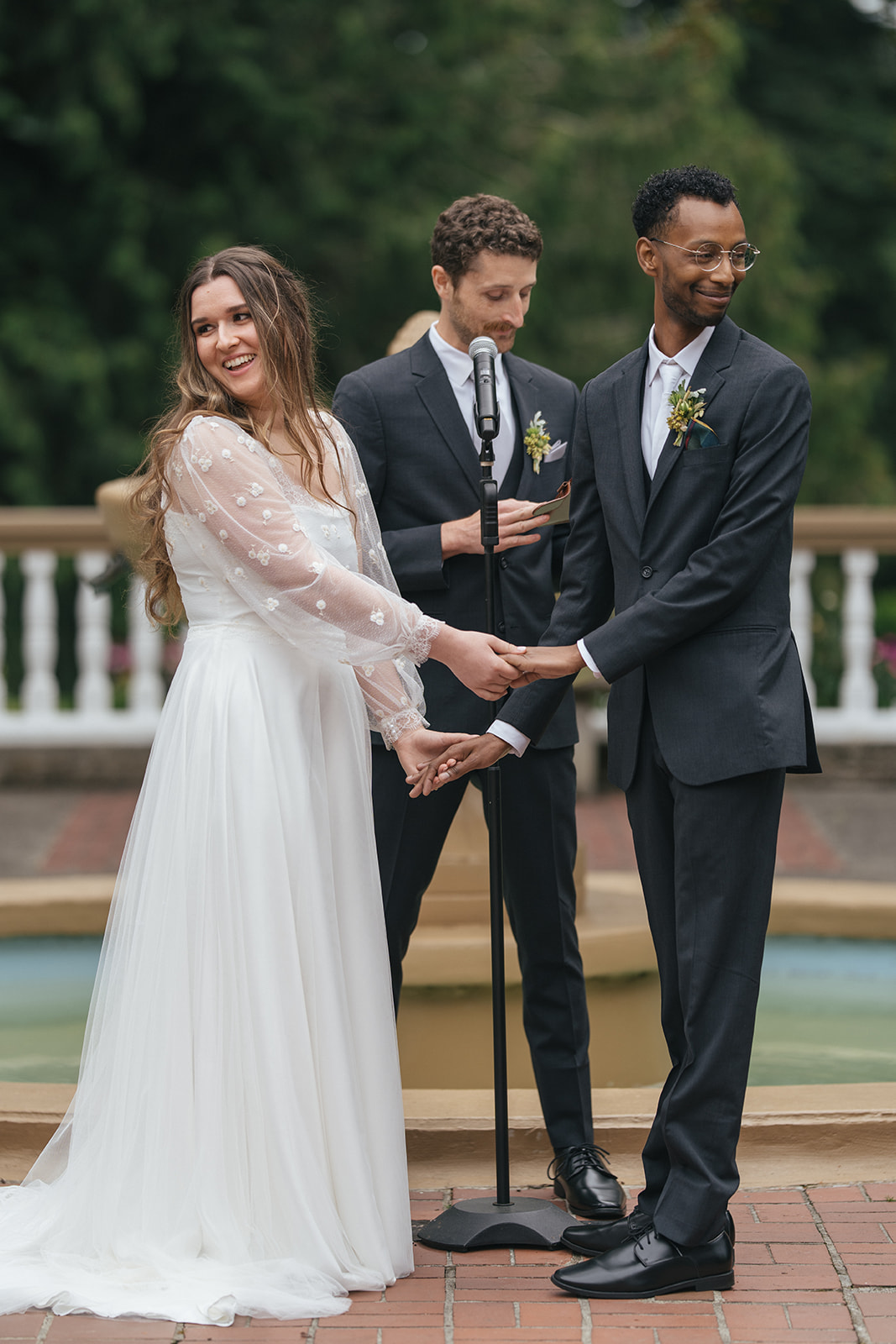 Couple holding hands during outdoor wedding ceremony at Lairmont Manor