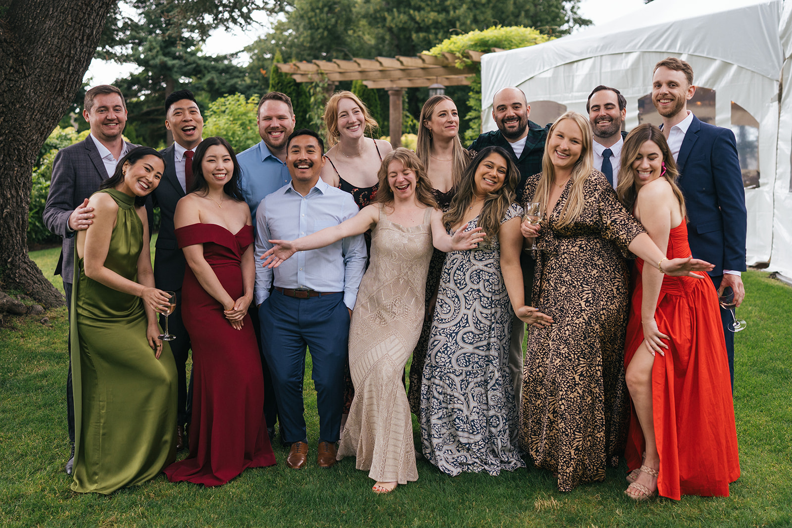 Wedding guests posing together for a group photo on the lawn during cocktail hour at Lairmont Manor