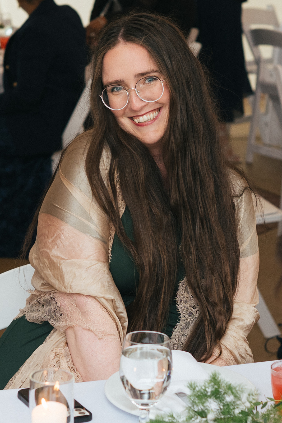 Guest smiling at reception table with string lights at Lairmont Manor wedding