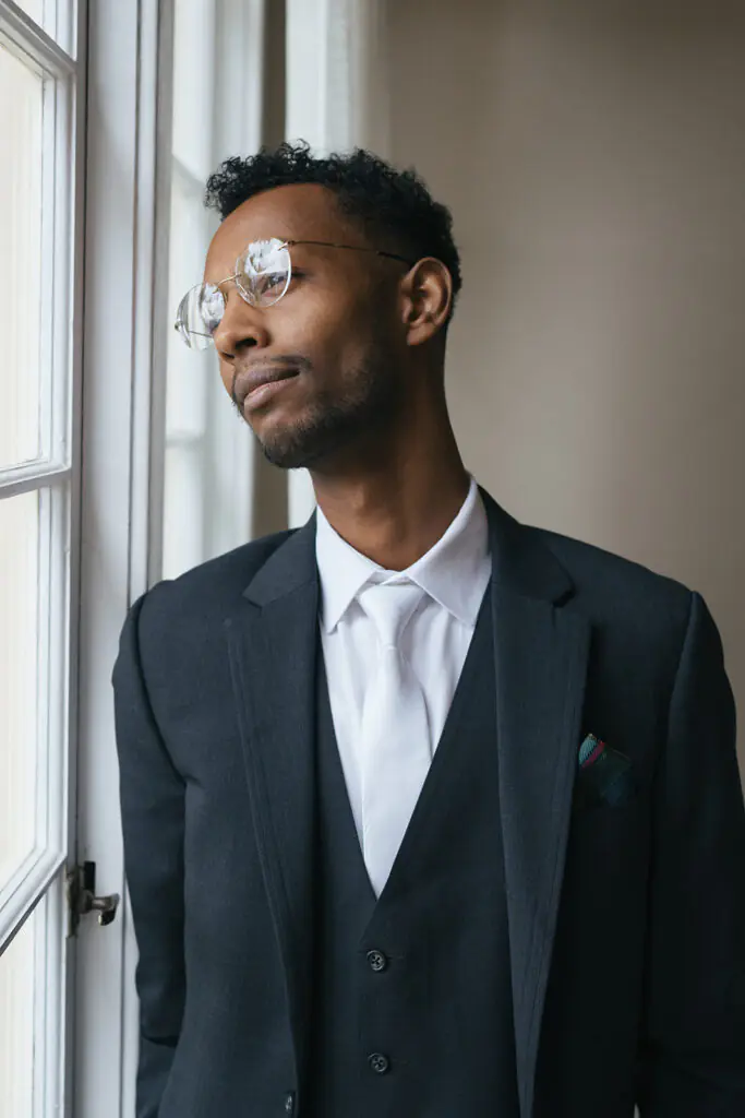 Groom portrait in natural light near window at Lairmont Manor wedding venue