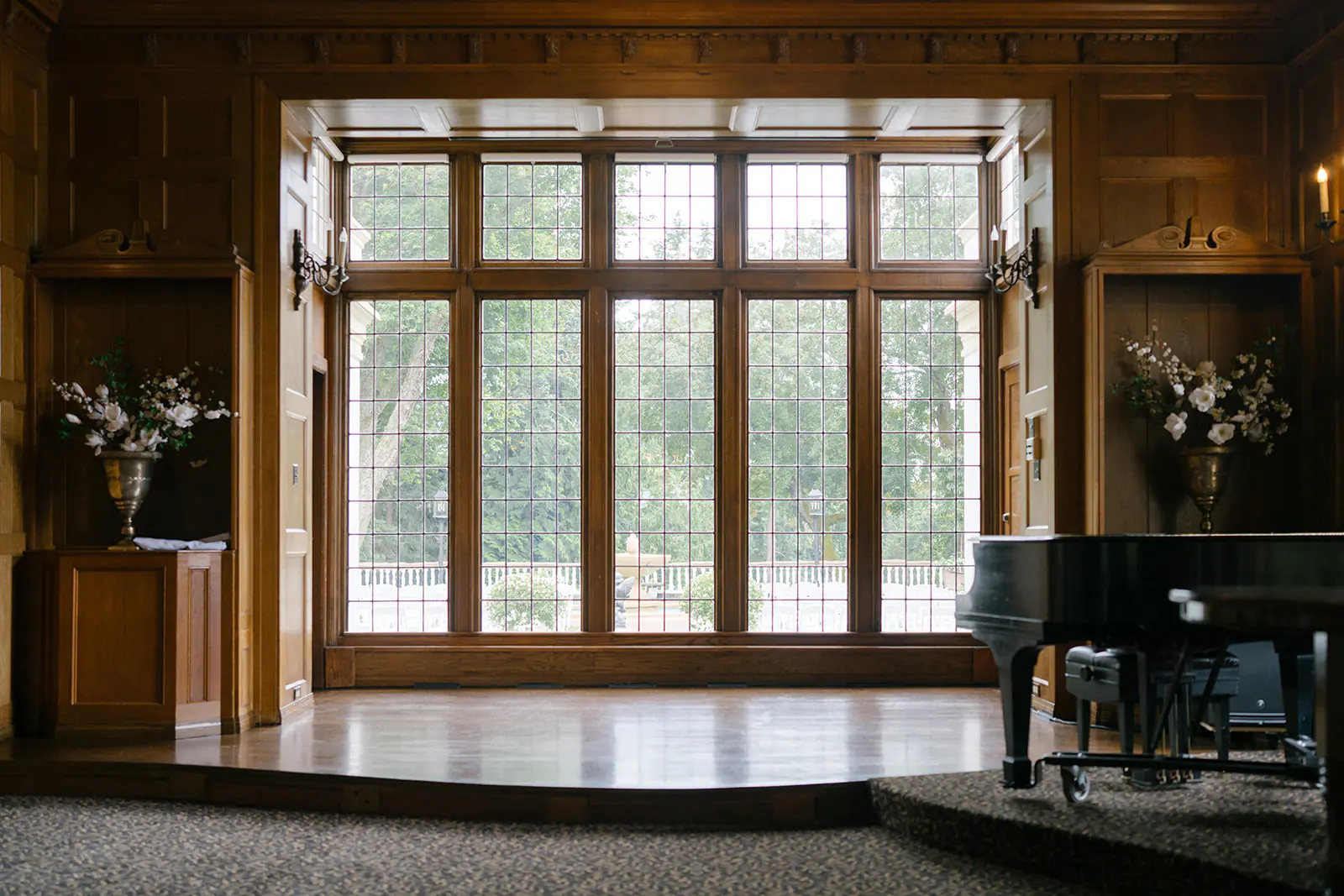 Ceremony space with large windows and grand piano inside Lairmont Manor