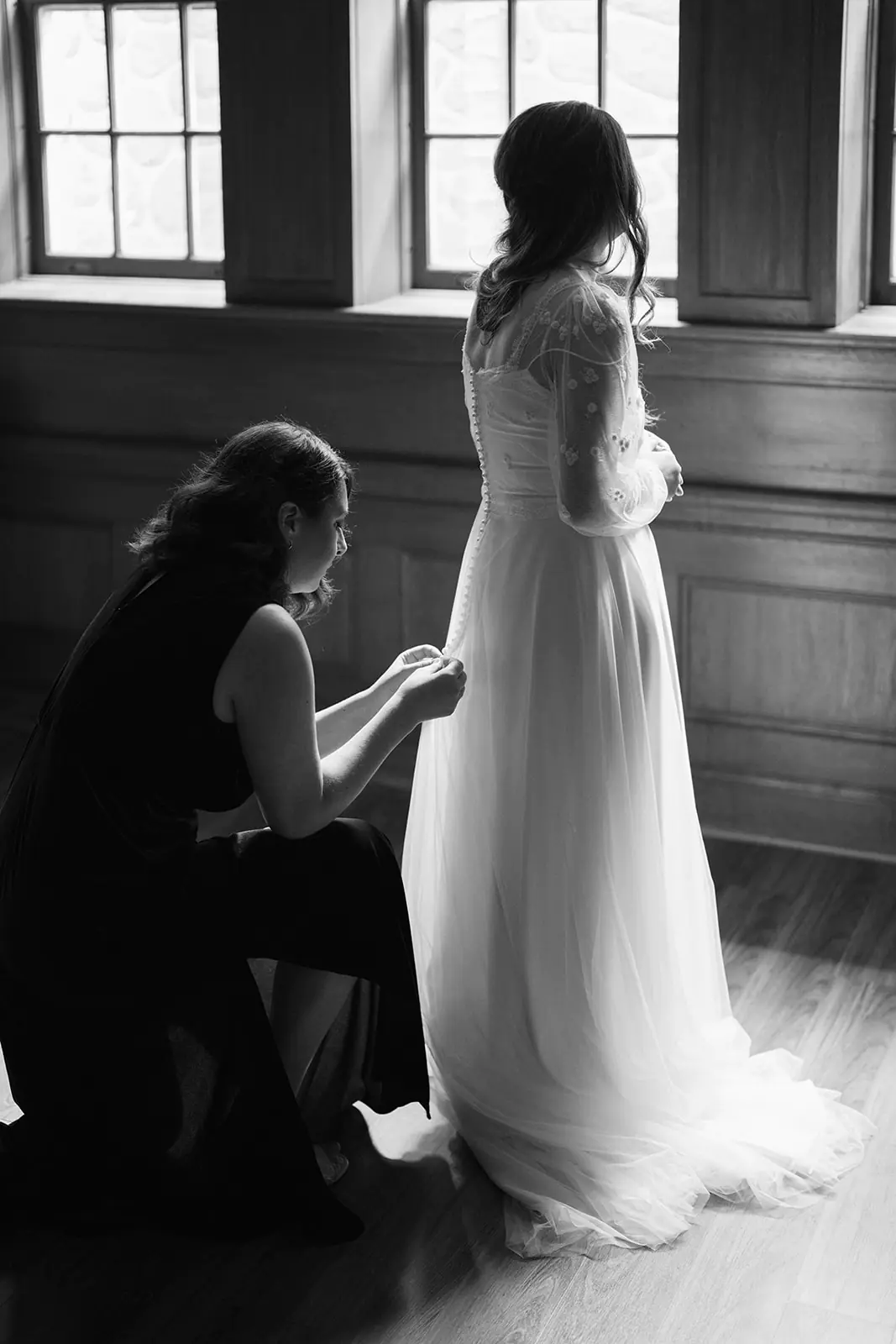 Bride having her wedding dress buttoned during preparations at Lairmont Manor