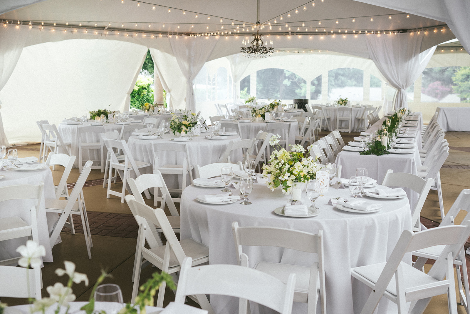 Elegant white reception tent with floral centerpieces and string lights at Lairmont Manor wedding