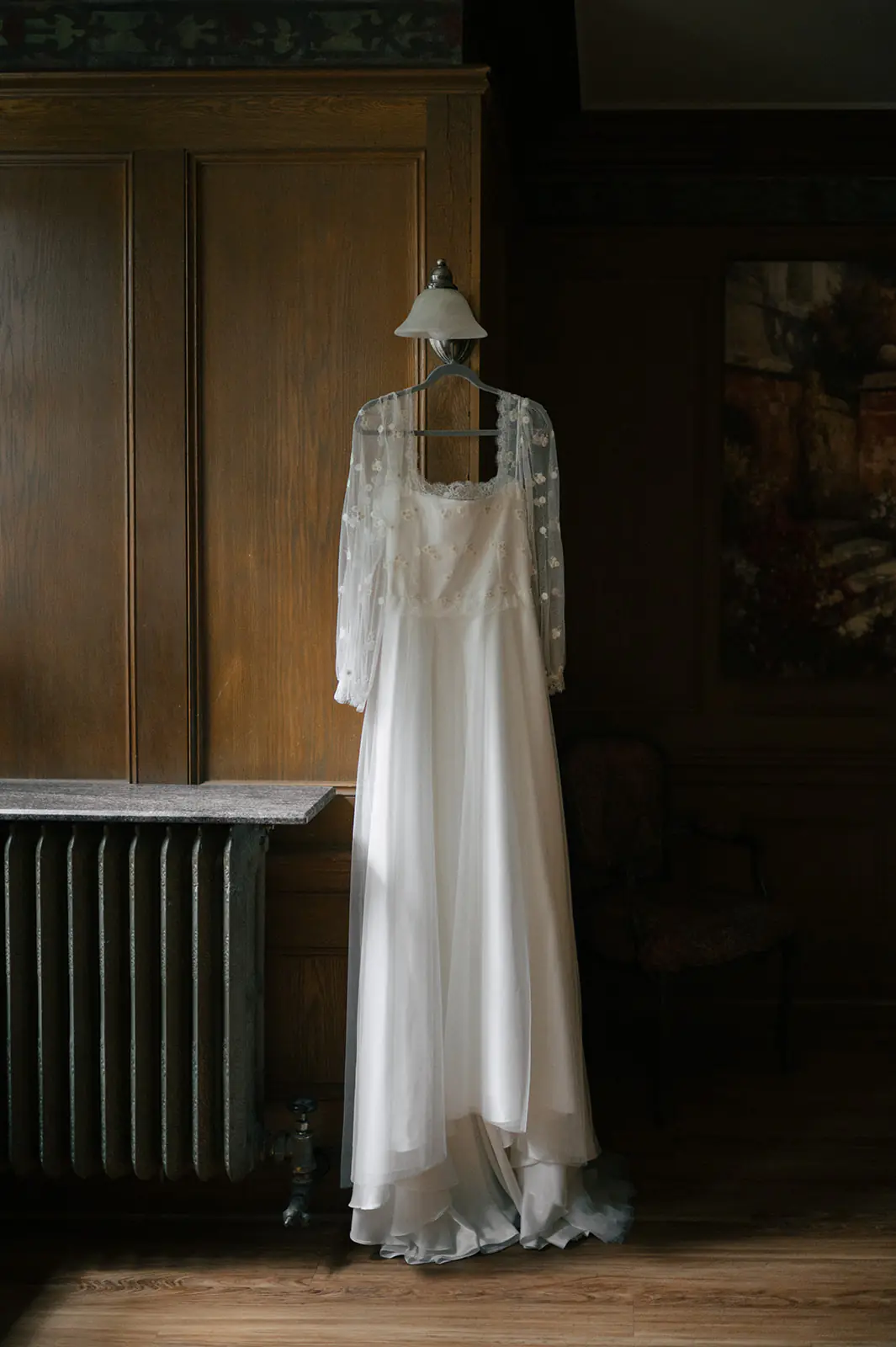 Wedding dress hanging in natural light inside Lairmont Manor