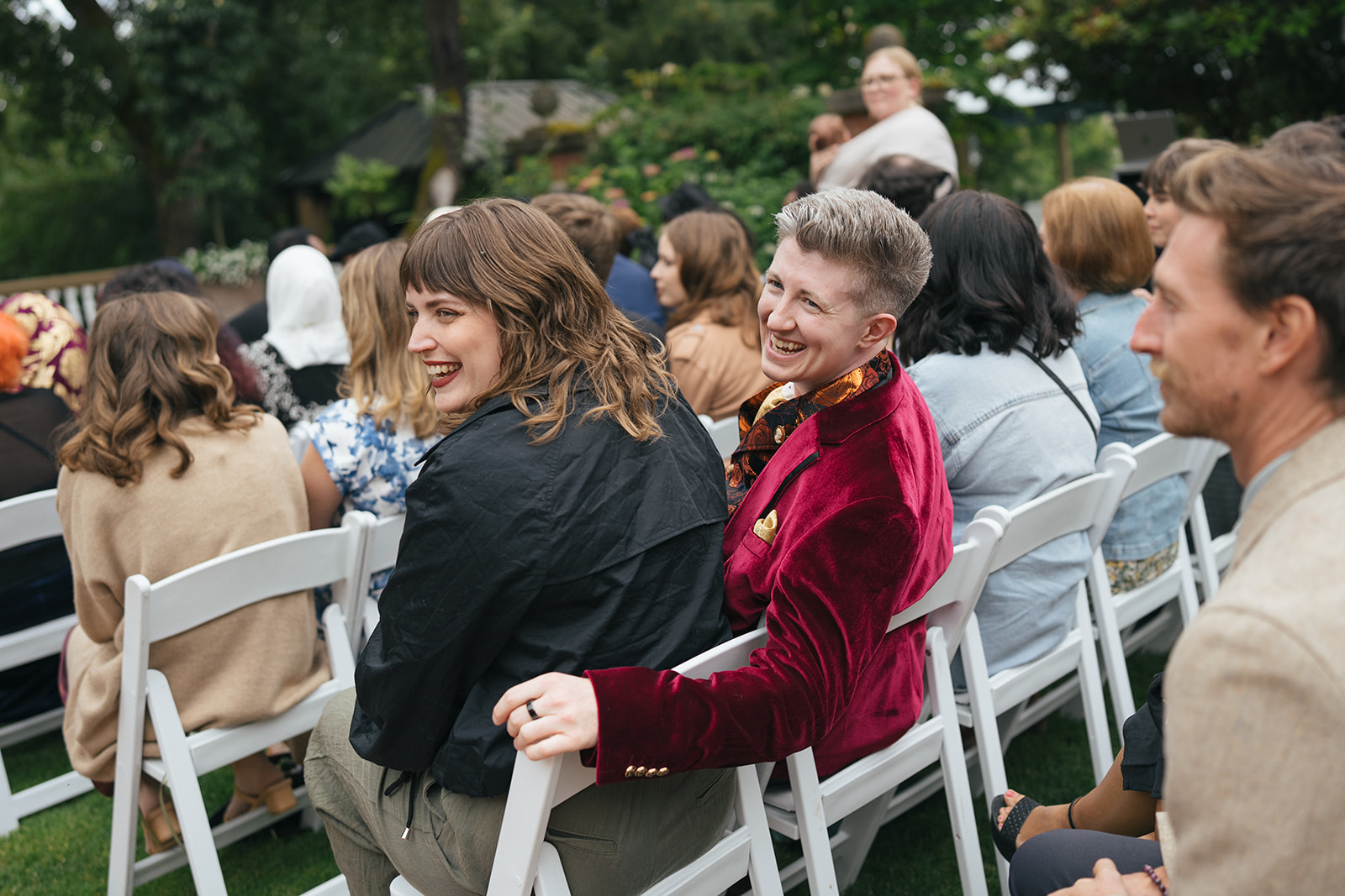Guests smiling and chatting before an outdoor wedding ceremony at Lairmont Manor