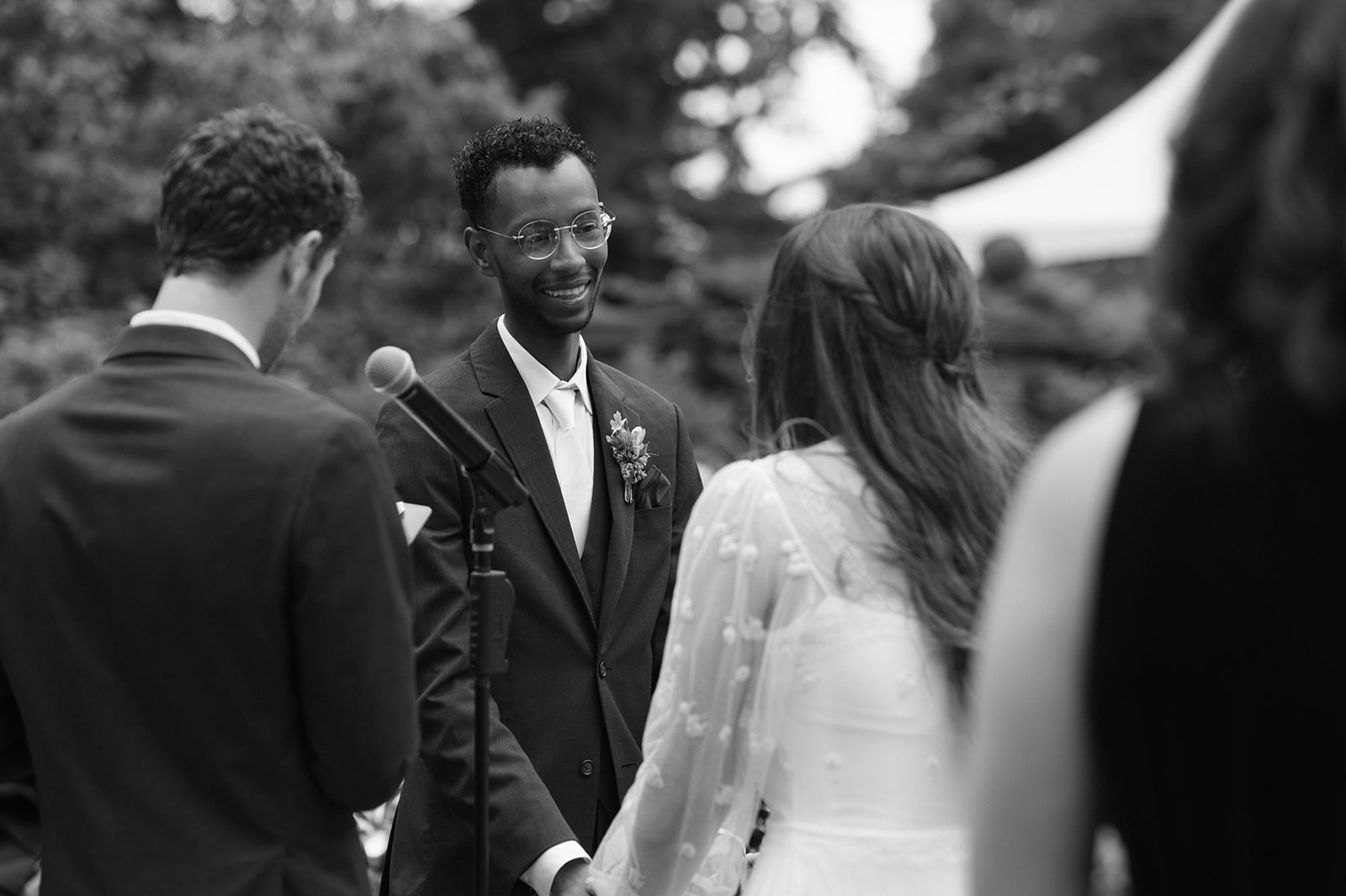 Groom smiling at bride during wedding ceremony at Lairmont Manor