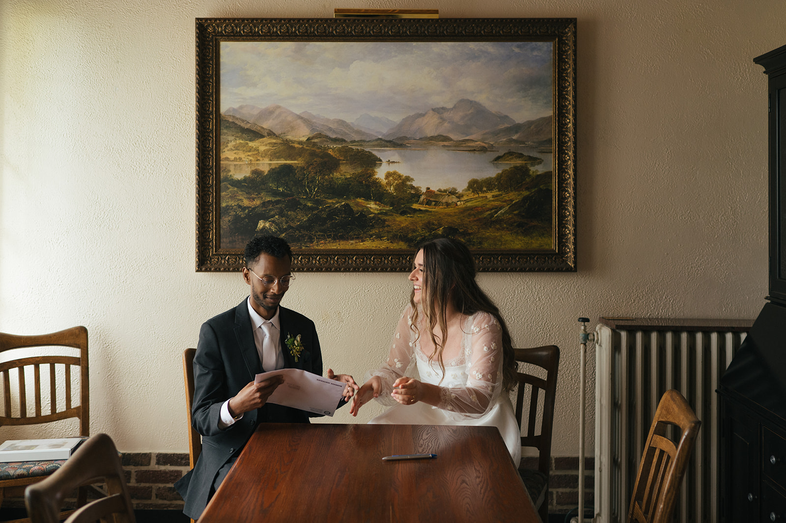 Newlyweds reviewing and signing their marriage license inside Lairmont Manor