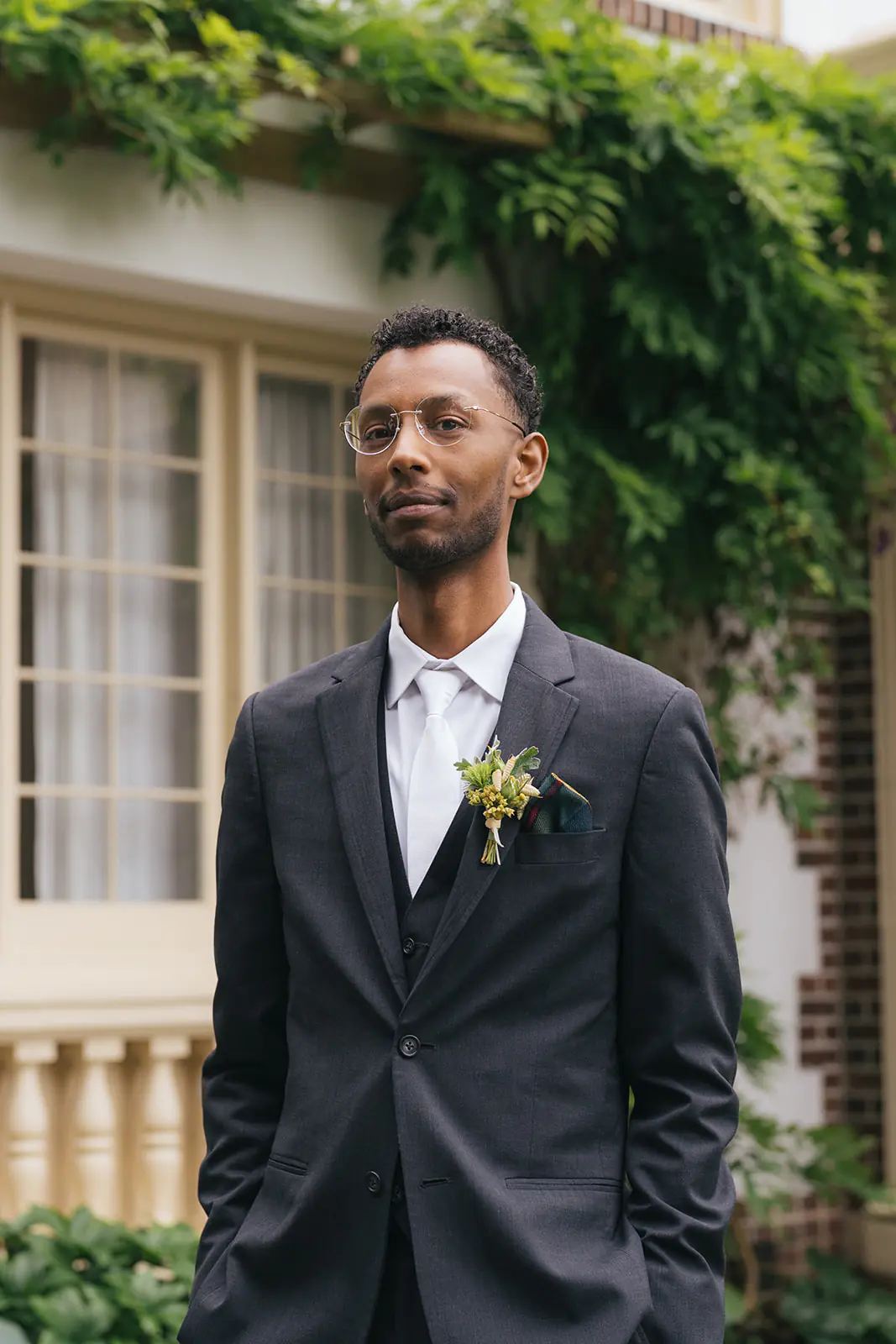 Groom waits outside Lairmont Manor in a tailored suit before the wedding first look.