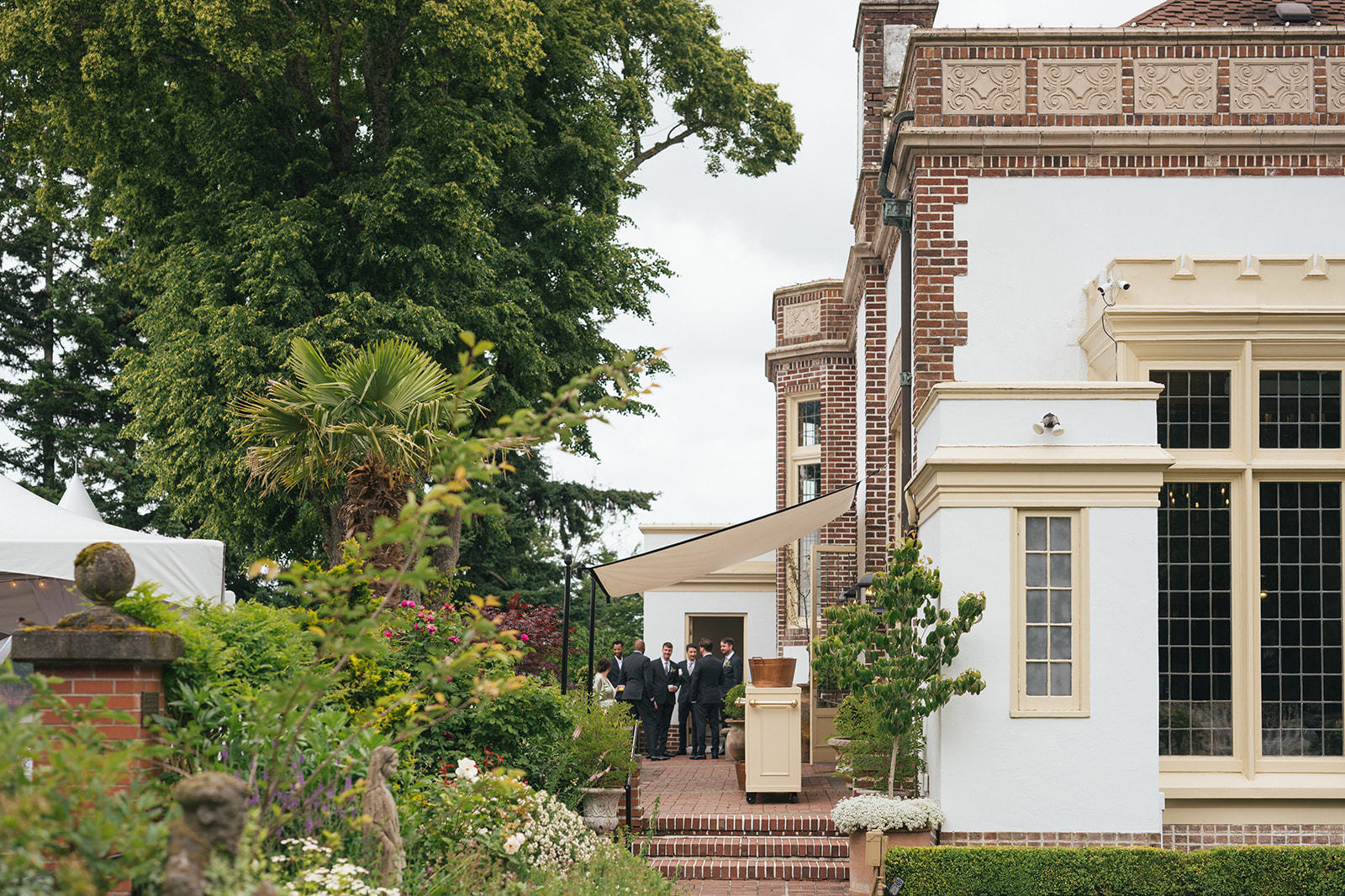 Exterior view of Lairmont Manor with wedding guests gathering near the entrance.