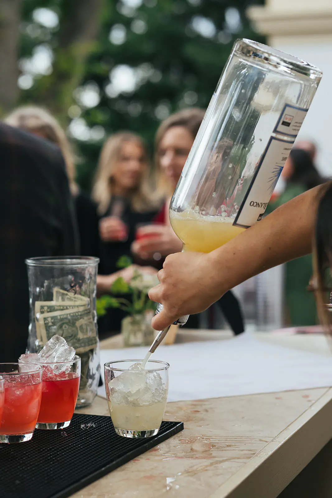 Bartender pouring cocktails for guests during outdoor Lairmont Manor wedding reception