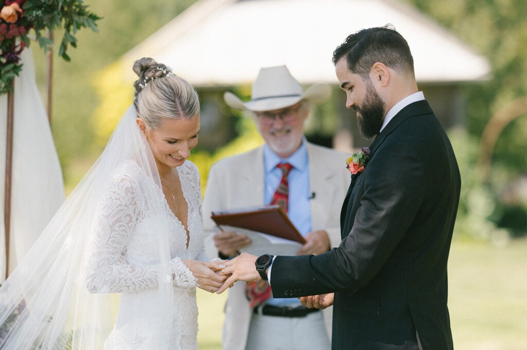 A newlywed couple shows off their rings moments after their Saltbox Barn wedding ceremony. Ask us about ring shots for your big day.
