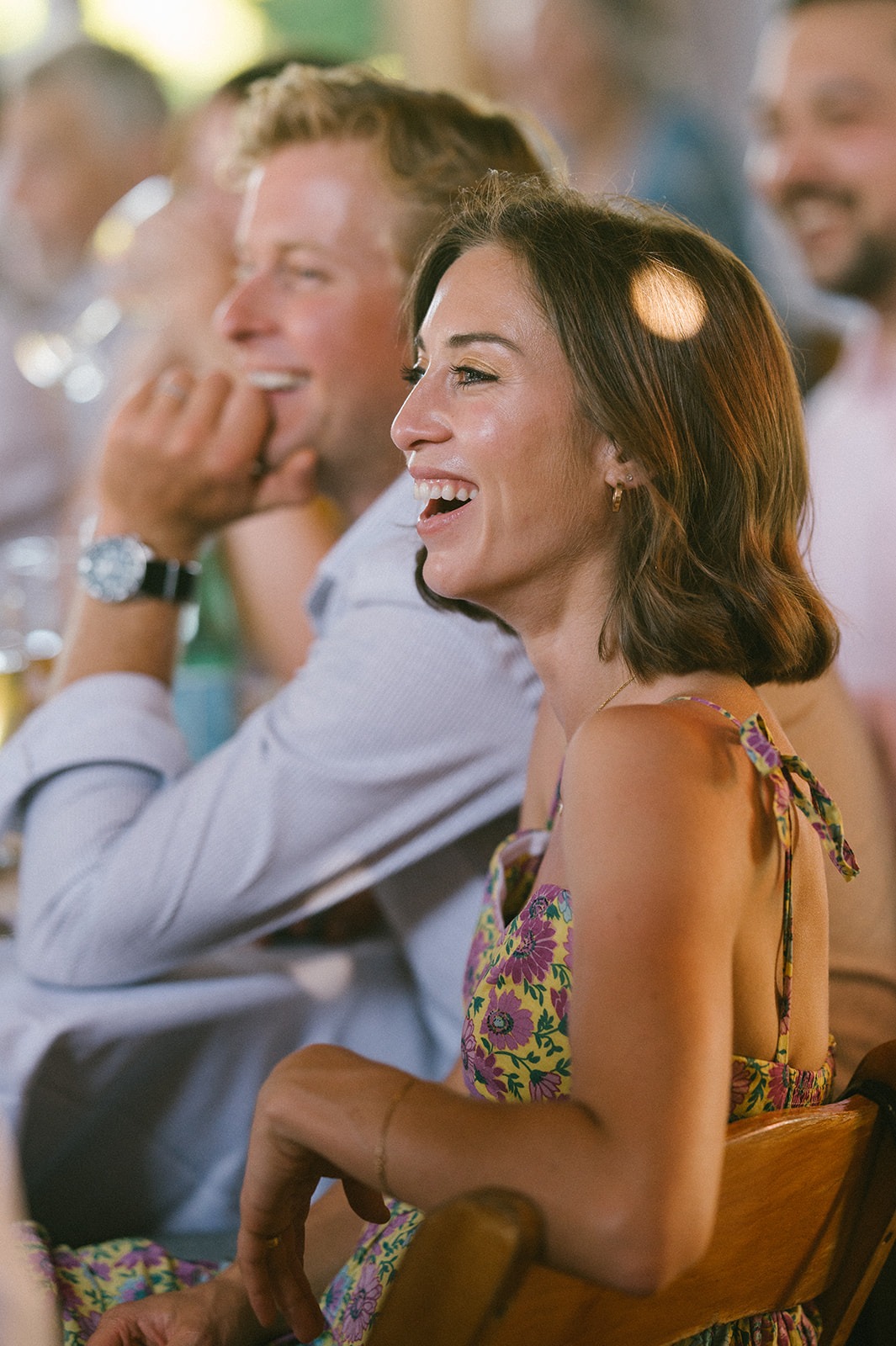 Two guests laugh during the shoe game at this Saltbox Barn wedding reception
