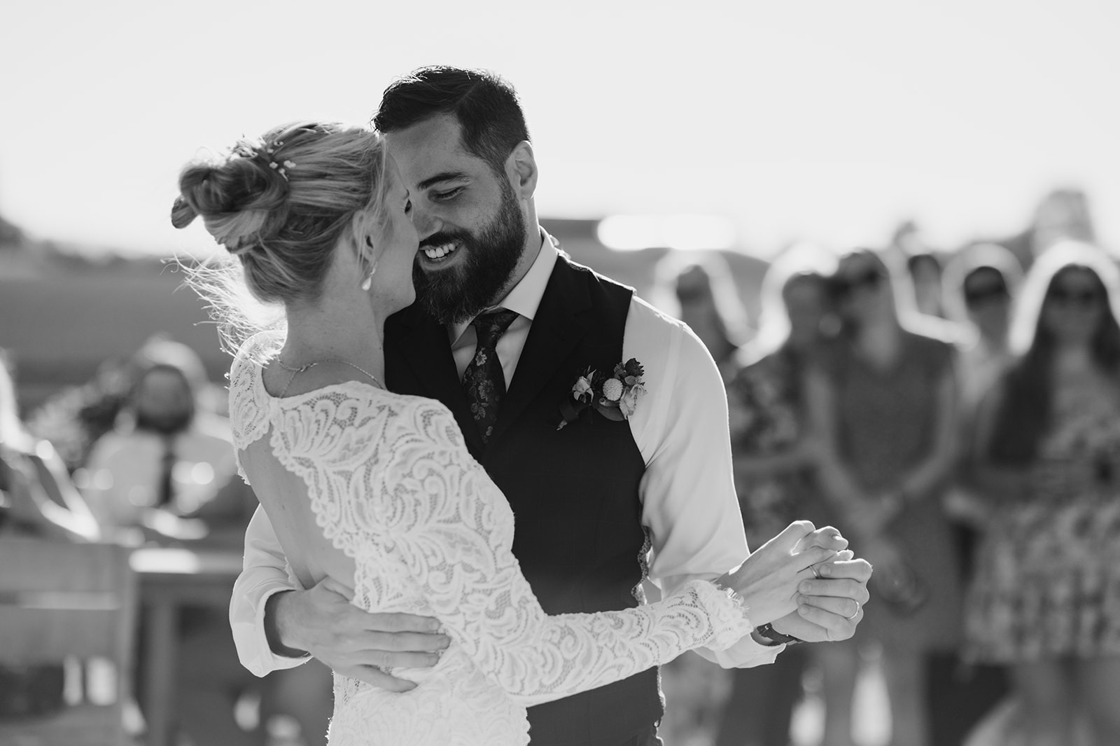 A black-and-white close-up captures the newlyweds swaying cheek to cheek