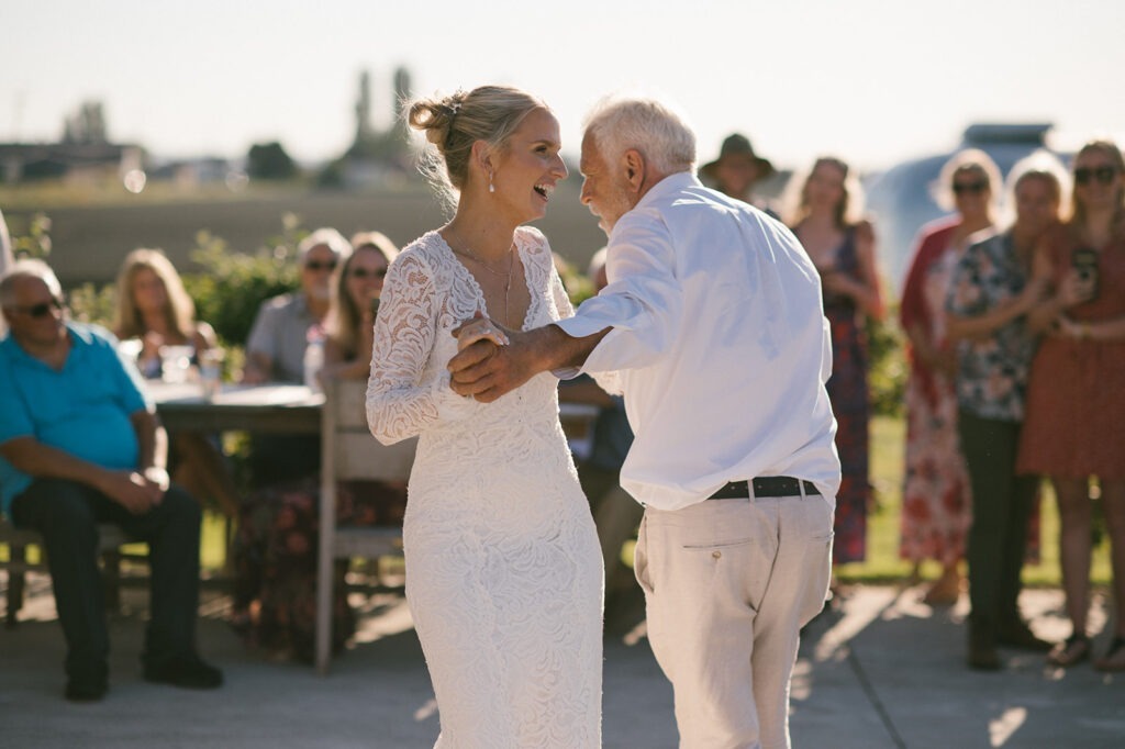 Bride dances with her father during this Saltbox Barn wedding reception
