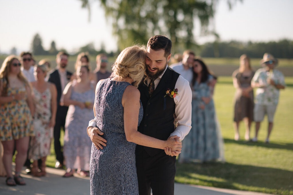 The groom shares a dance with his new mother-in-law at the reception
