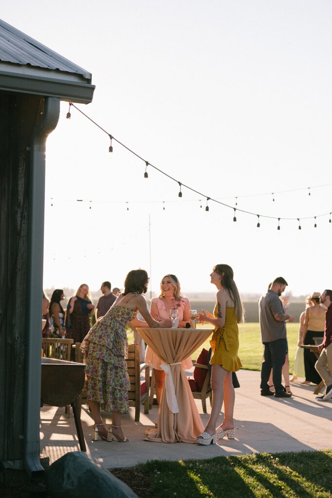 String lights glow over guests gathered near the patio bar area